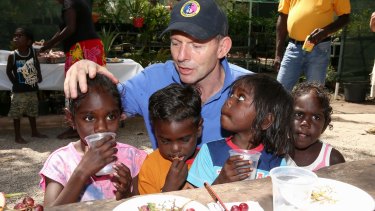 Tony Abbott meets with children from the Gunyangara community during a visit to North East Arnhem Land last year.