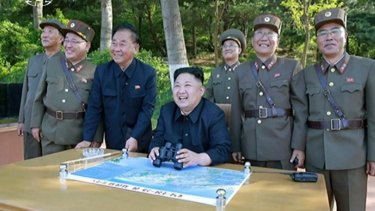 Kim Jong Un, centre, watches the test launch of missile at an undisclosed location in North Korea.