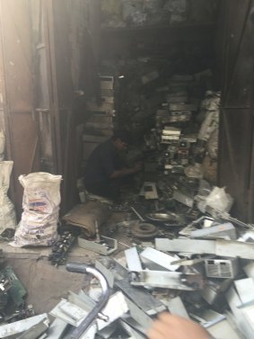 E-waste worker dismantles circuit boards at a small shop in Shastri Park, Delhi.