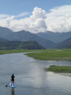 Stand-up paddleboarding with Himalayan Yogini in Nepal.
