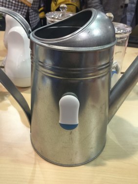 A cookie attached to a watering can.