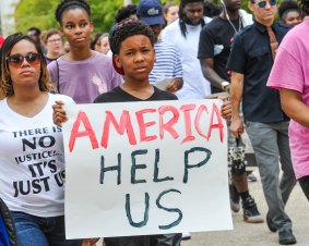 Protesters hold signs in Baton Rouge, Louisiana.