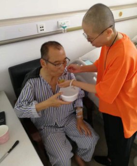 In this undated handout photo,  Liu Xiaobo, left, attended to by his wife Liu Xia in a hospital in China. Liu Xiaobo was released from prison on medical parole after being diagnosed with late-stage liver cancer. But he was not allowed to leave the country to get medical treatment in the West.