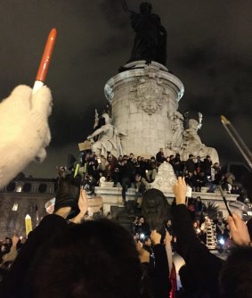 Mighty pen: Protesters at the Place de la Republique in Paris.