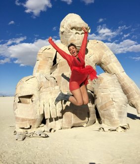 Carla O'Brien, pictured here with a sculpture at Burning Man.