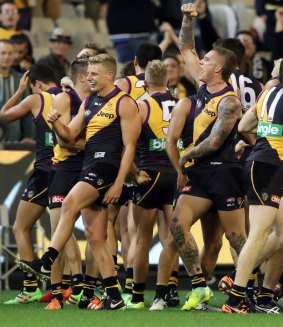 Overjoyed: The Tigers celebrate their round eight victory over the Swans on Saturday night.