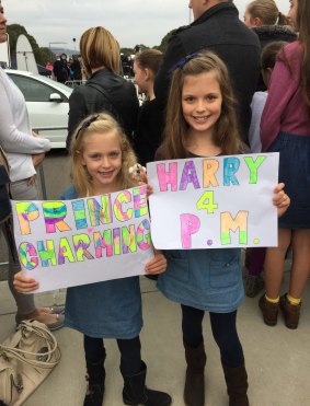 Mia Cooper, 7, with her big sister Ella, 9 wait to meet Prince Harry.