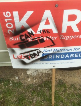 A sign for Labor candidate Karl Maftoum, which was defaced near Drakeford Drive.