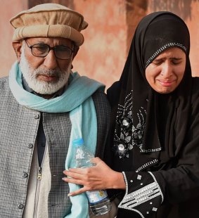 Family members arrive at the school in Peshawar.