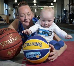 Former Canberra Capitals player Michelle Cosier with young son Levi in August. Cosier has taken up a position in the refereeing ranks with Basketball ACT.  