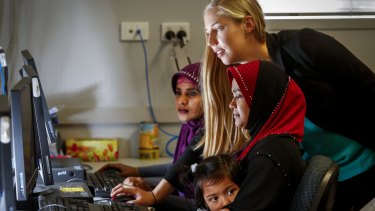 Zoe Seeberg-Gordon (centre) from the Australian Multicultural Foundation teaching IT skills to recent migrants so they can better understand what kids are looking at online.