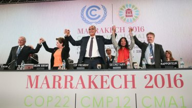 UN climate chief Patricia Espinosa, second left, and Morocco's Foreign Minister Salaheddine Mezouar, centre, celebrate at the COP22 climate change conference in Marrakech.