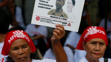 Supporters of the late Philippine dictator Ferdinand Marcos  await the rulling in Manila.