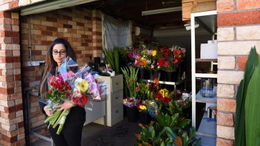 Florist Rita Sakr at work in her garage after she had to close her shop when she wasn't paid by Ready Flowers. 