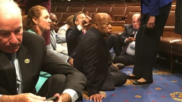 Democrat members of Congress, including Representatives John Lewis (centre) and Joe Courtney participate in sit-down protest seeking a  vote on gun control measures.