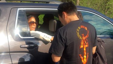 'You know he really took care of himself. He ate well. He ate better than me' ... Former Prince drummer Sheila E consoles a fan as she leaves Paisley Park estate near Minneapolis.