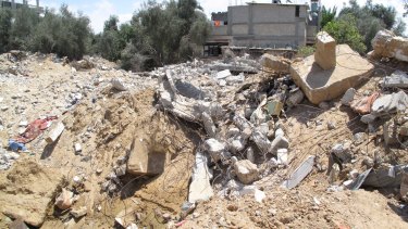 The remains of the Abu Jame family's three-storey apartment block destroyed in an airstrike, in which 26 people died.