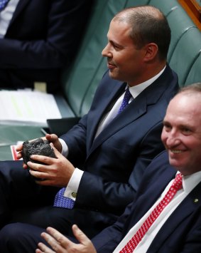 Energy and Environment Minister Josh Frydenberg gets his turn with the lump of coal in question time next to Deputy Prime Minister Barnaby Joyce. 