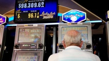 A man plays the pokies at Mounties Club in Mount Pritchard in the City of Fairfield, whose residents wagered nearly $8.5 billion last year. 