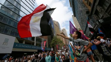 Kyrollos Ayaad, 9, waves an Egyptian flag at a rally organised by the Australian Coptic Movement Association.