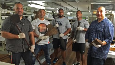 Pacific pride: Logan Metcalfe (Tewhatewha), Nigel Vagana (Talinga loa), Junior Paulo (Akau anave), Manu Ma'u (Apa'apai) and Leo Tanoi (holding a Nifo oti), with Polynesian tools at the Australian Museum.