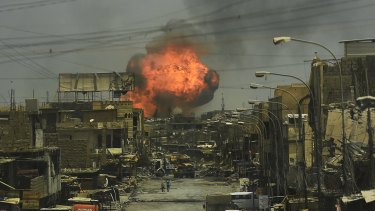 A fireball explodes in the air above the shattered streets of west Mosul on July 3, 2017.