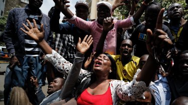 Supporters of opposition leader Raila Odinga kneel down and thank God as they celebrate the verdict in downtown Nairobi, Kenya.
