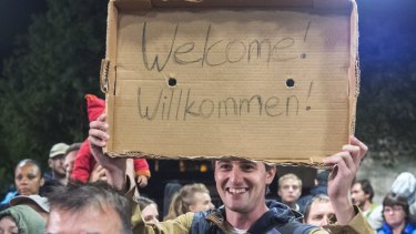 Crowds welcome refugees at the train station in Saalfeld, central Germany. Hundreds of refugees arrived by train from Munich to be transported by buses to an accomodation centre. 