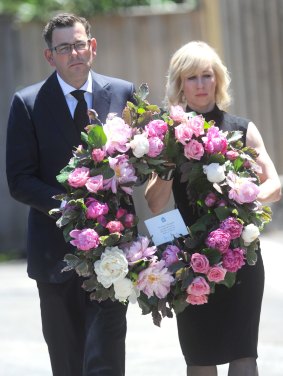 Premier Daniel Andrews and wife Cath carry a wreath at the state funeral of Lynne Kosky.