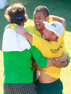 Thanasi Kokkinakis, Nick Kyrgios and Lleyton Hewitt celebrate Australia's Davis Cup quarter-final win over Kazakhstan in July.