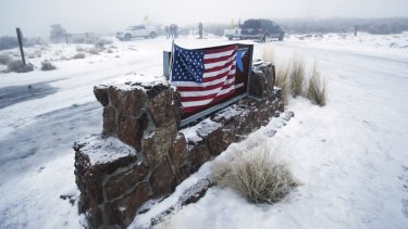 An American flag attached to the sign at the front entrance of the Malheur National Wildlife Refuge on Thursday.