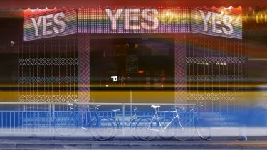 A bus leaves light trails as it passes a bar promoting the 'Yes' vote in central Dublin.