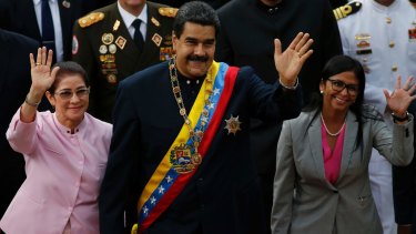 Venezuelan President Nicolas Maduro, centre, with his wife Cilia Flores, left, and Constitutional Assembly President Delcy Rodriguez wave as they arrive to the National Assembly on Thursday,