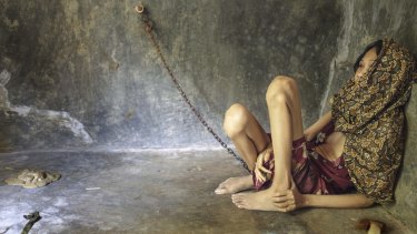 A woman chained in a room built behind her family home in Ponorogo, East Java. 