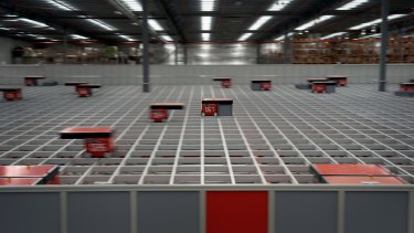 Robots dance above the two-story shafts at the Catch Group's warehouse, picking up and sorting online orders.