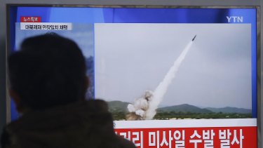 A man watches a news bulletin showing footage of a missile launch conducted by North Korea.