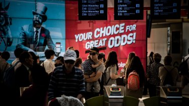 Ladbrokes sports betting agency advertising at Flinders Street station.