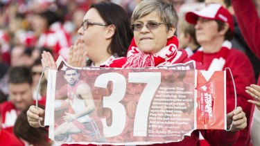 Fans support Adam Goodes with the Fairfax poster.