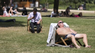 Britons enjoy the warm weather in St James's Park, London.