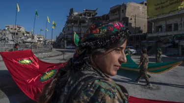 Fighters from the Kurdish female militia, the Women's Protection Units, or YPJ, hold a celebration in Paradise Square in Raqqa, Syria, last October.