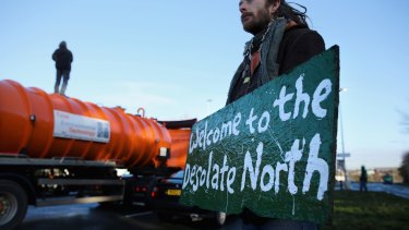 An anti-fracking protester stands on top of a truck carrying chemicals to the Barton Moss gas fracking facility in 2014.