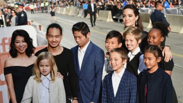 Vivienne Jolie-Pitt, front row from left, Knox Jolie-Pitt, Sareum Srey Moch, middle row from left, Loung Ung, Maddox Jolie-Pitt, Pax Jolie-Pitt, Kimhak Mun, Shiloh Jolie-Pitt, Zahara Jolie-Pitt and Angelina Jolie at the premiere of 'First They Killed My Father' at the Toronto International Film Festival.