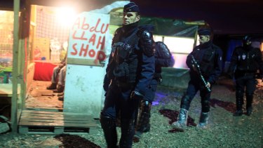 French riot police patrol in the migrant camp in Calais earlier this month. 