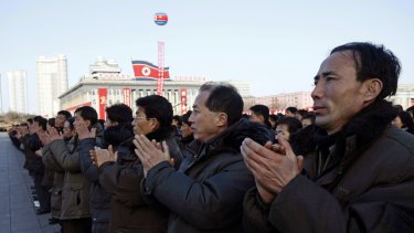 North Koreans applaud after North Korea said Wednesday it had conducted a hydrogen bomb test.
