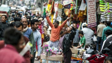 Salespeople at an open market on the busy streets of Old Delhi.