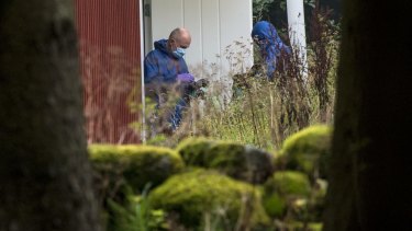 Police forensic officers work at a property outside Knislinge in southern Sweden connected with the abduction case.