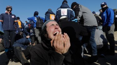 A settler reacts as police evict the last settlers from the West Bank outpost of Amona on Thursday.