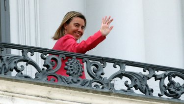 European Union High Representative Federica Mogherini waves on Monday from a balcony of the Palais Coburg where closed-door nuclear talks with Iran continue.