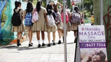 Case dismissed: Pupils from Hornsby Girls' High School walk past a massage parlour that won a legal battle with the council.
