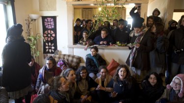 Israeli settlers, including children, barricade themselves in a house in Amona, West Bank, as Israeli security forces arrive.